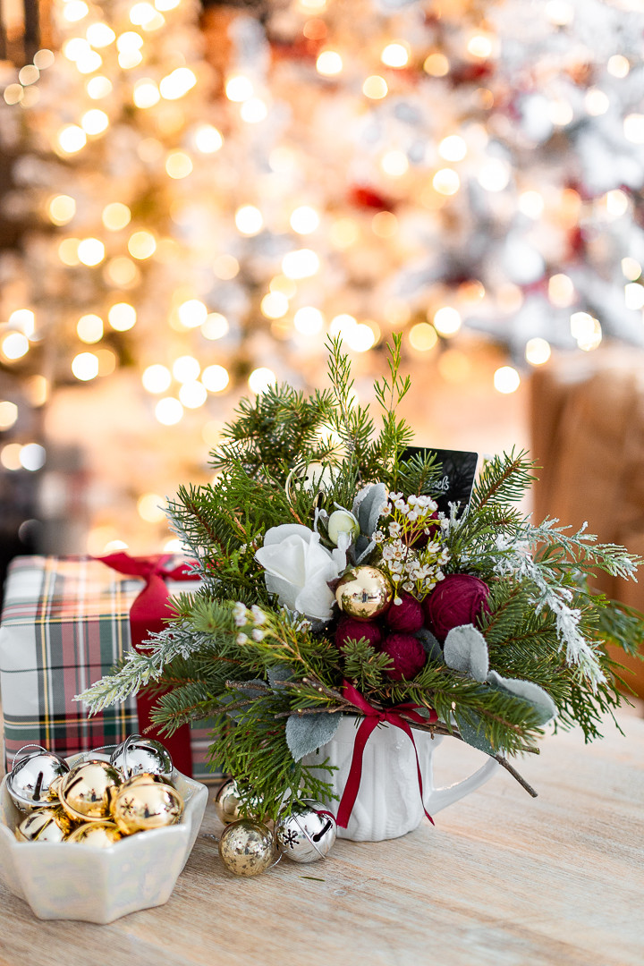Side view of the small Christmas flower arrangement in a knitted mug, showing the compact size ideal for a small Christmas gift