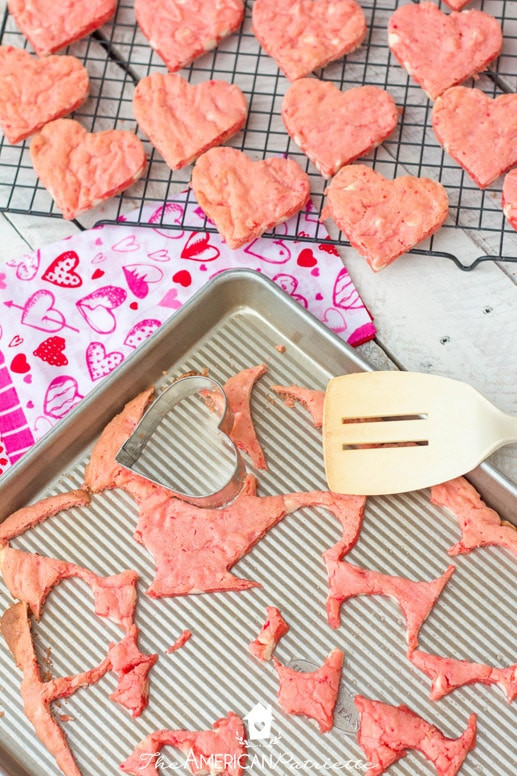Vibrant pink heart-shaped strawberry cookies with white chocolate chips, simple and sweet homemade Valentine's gifts