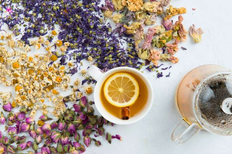A beautifully arranged custom tea box, featuring various tea flavors and a teacup, suggesting a comforting and relaxing gift option.