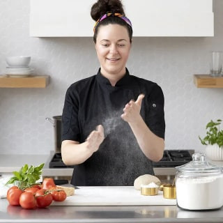 Chef instructing a virtual cooking class on making pasta and marinara sauce.