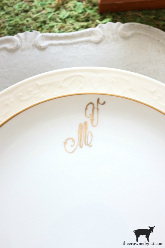 Monogrammed vintage dishes, elegantly arranged to highlight their personalized details and sophisticated appeal for formal or casual settings.