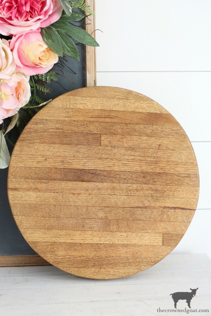 A close-up of a vintage wooden breadboard, emphasizing its aged patina and practical kitchen use, reminding of the need for thorough cleaning.