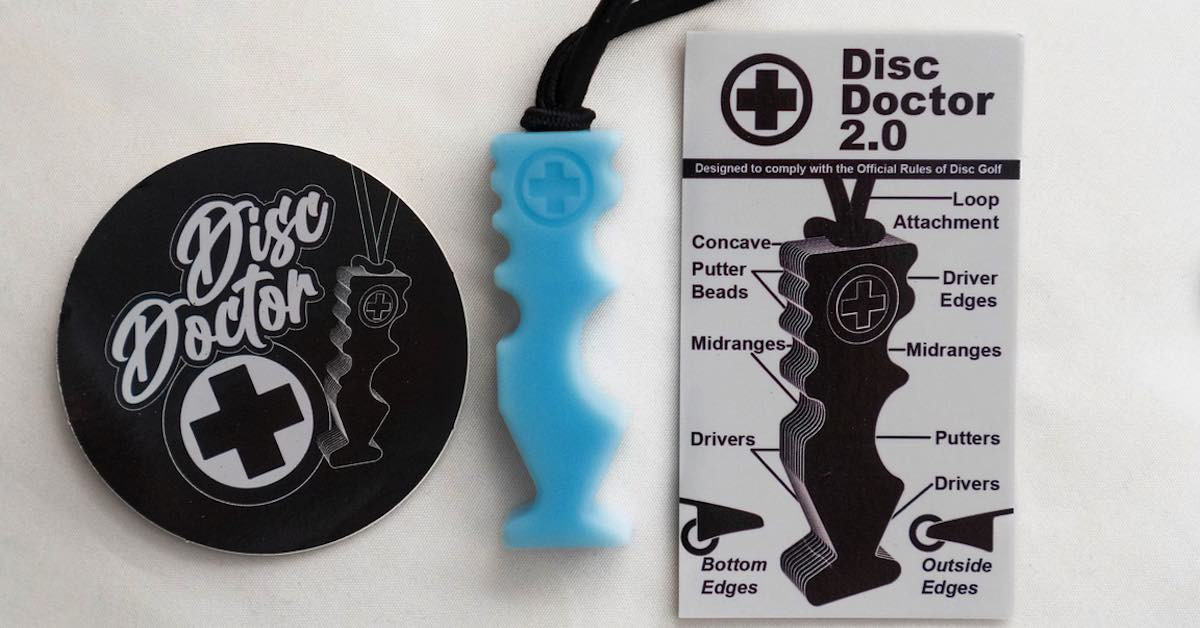Blue disc golf disc repair tool next to a Disc Doctor branded plastic circle