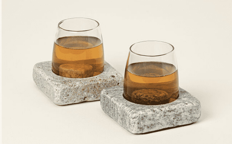 Granite wine chilling coasters paired with wine glasses, presented as a sophisticated and functional gift for wine enthusiasts