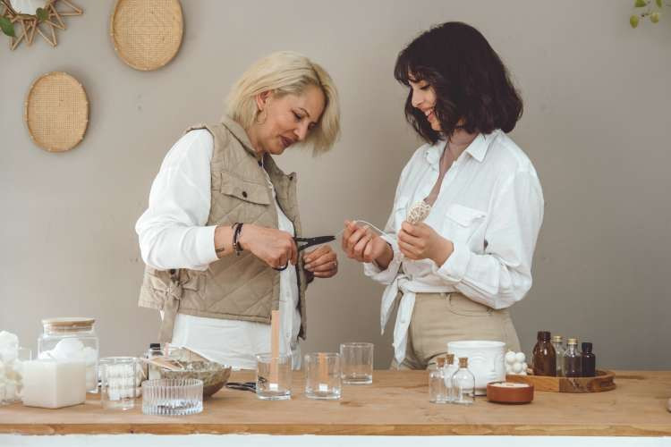 mother and daughter making candles with kit