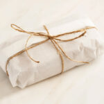 A loaf wrapped in parchment for How to Wrap Quick Bread for Gifting