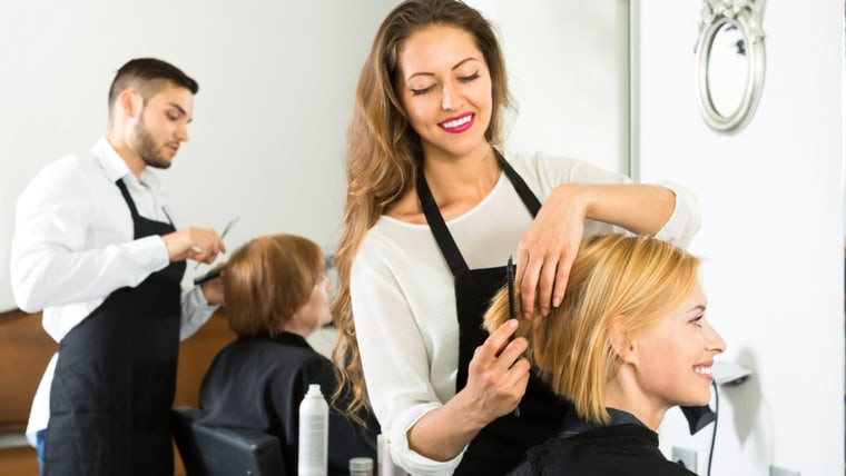 hairdresser trimming hair