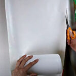 measuring and cutting gift wrapper