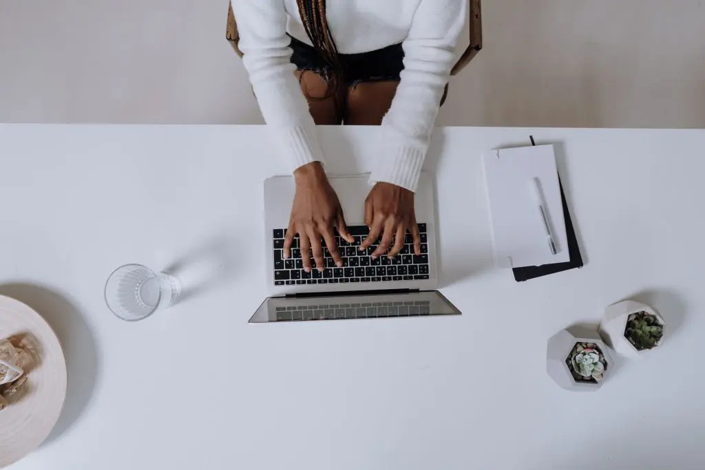 Woman using laptop for retail arbitrage, symbolizing entrepreneurial spirit and financial opportunity