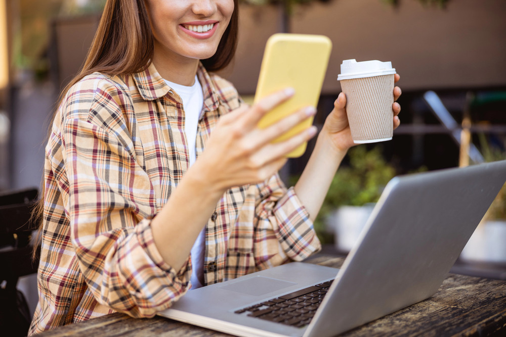 A woman uses Ibotta on her smartphone for cashback rewards while shopping for attorney gifts